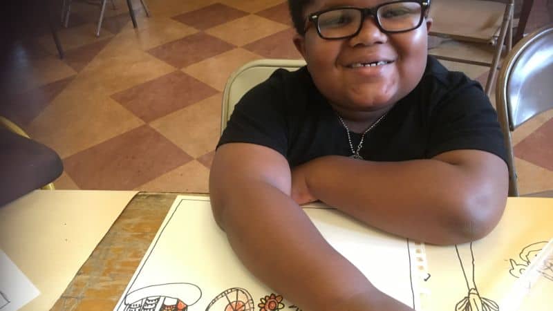 Smiling African American boy in class