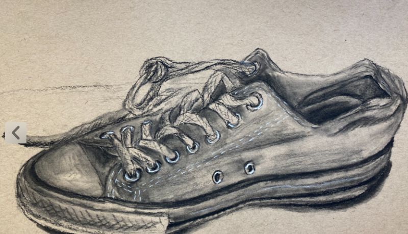 A converse shoe drawn in black and white with charcoal on white paper